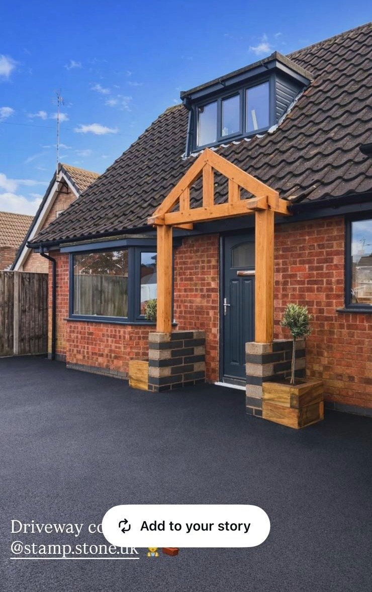Completed front entrance and paved approach with a timber porch at a residential property