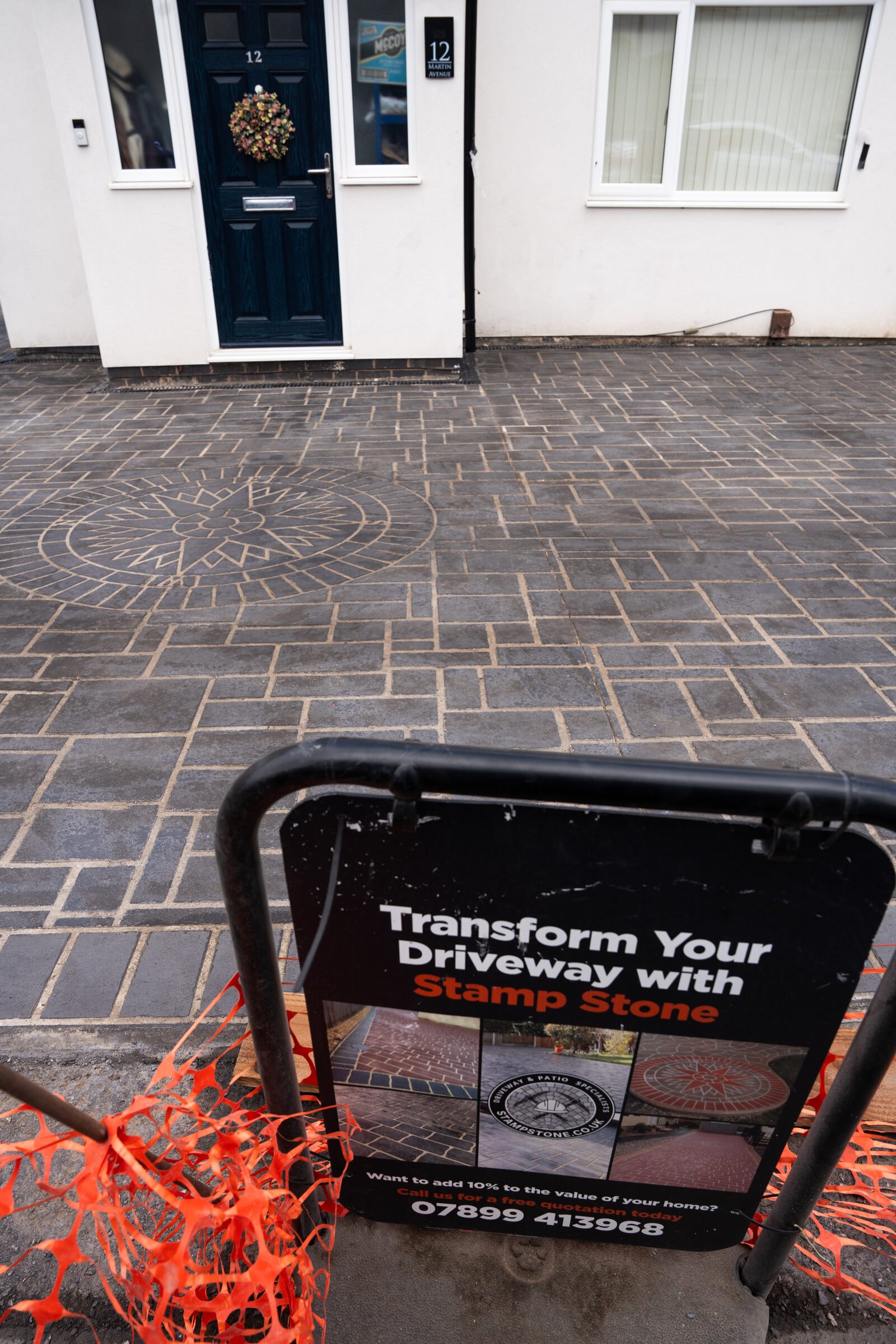 Stamp Stone site sign displayed on the completed decorative driveway