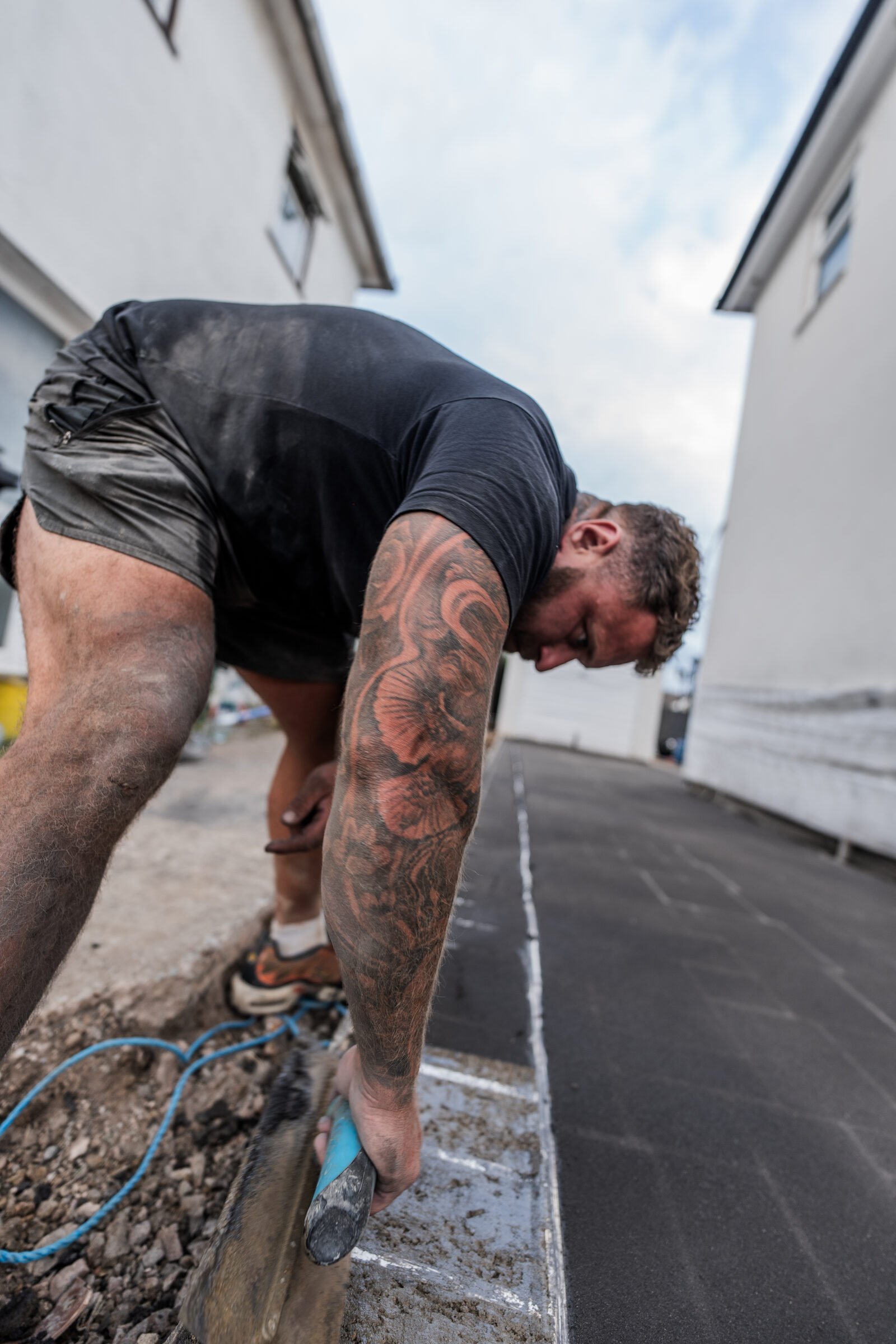 Decorative concrete edge detail being carefully finished by hand