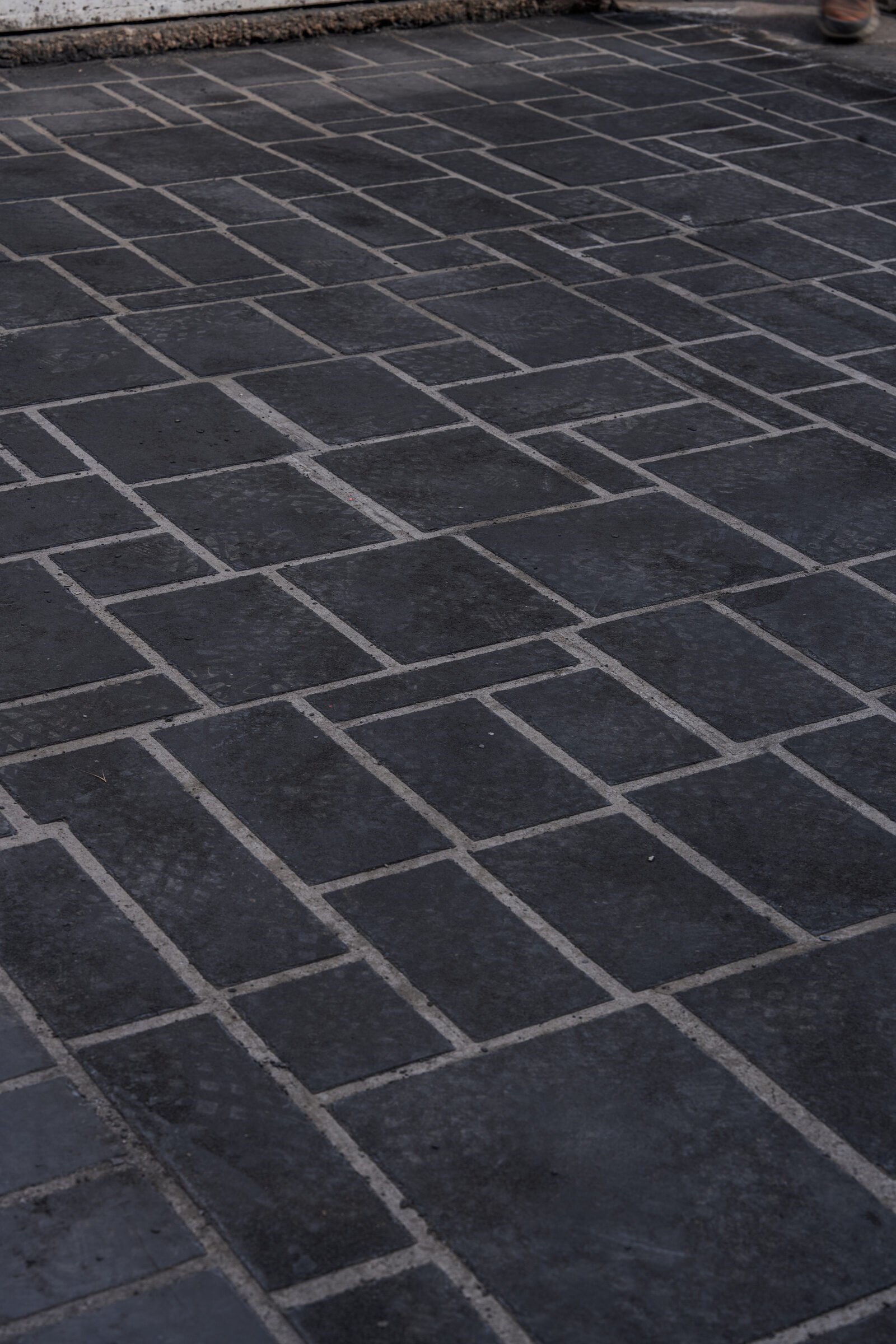 Close-up of the finished dark pattern-imprinted concrete surface