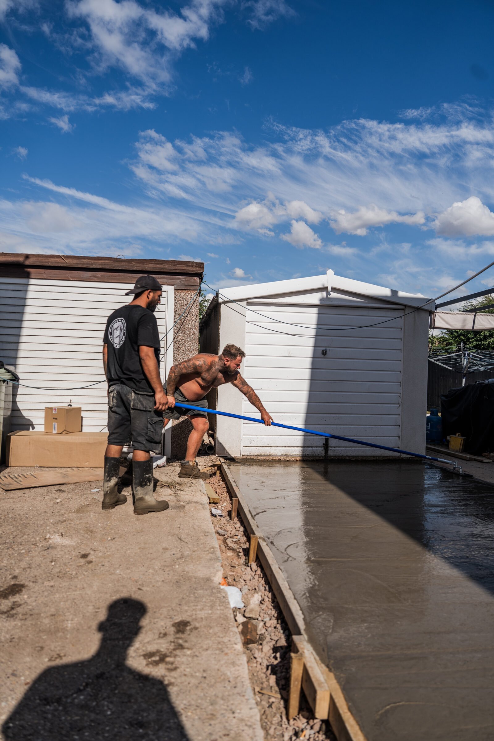 Stamp Stone team levelling freshly poured driveway concrete