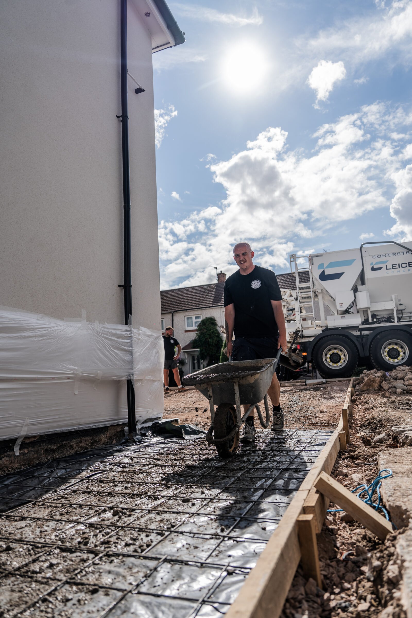 Concrete being poured over reinforcement for a pattern-imprinted driveway