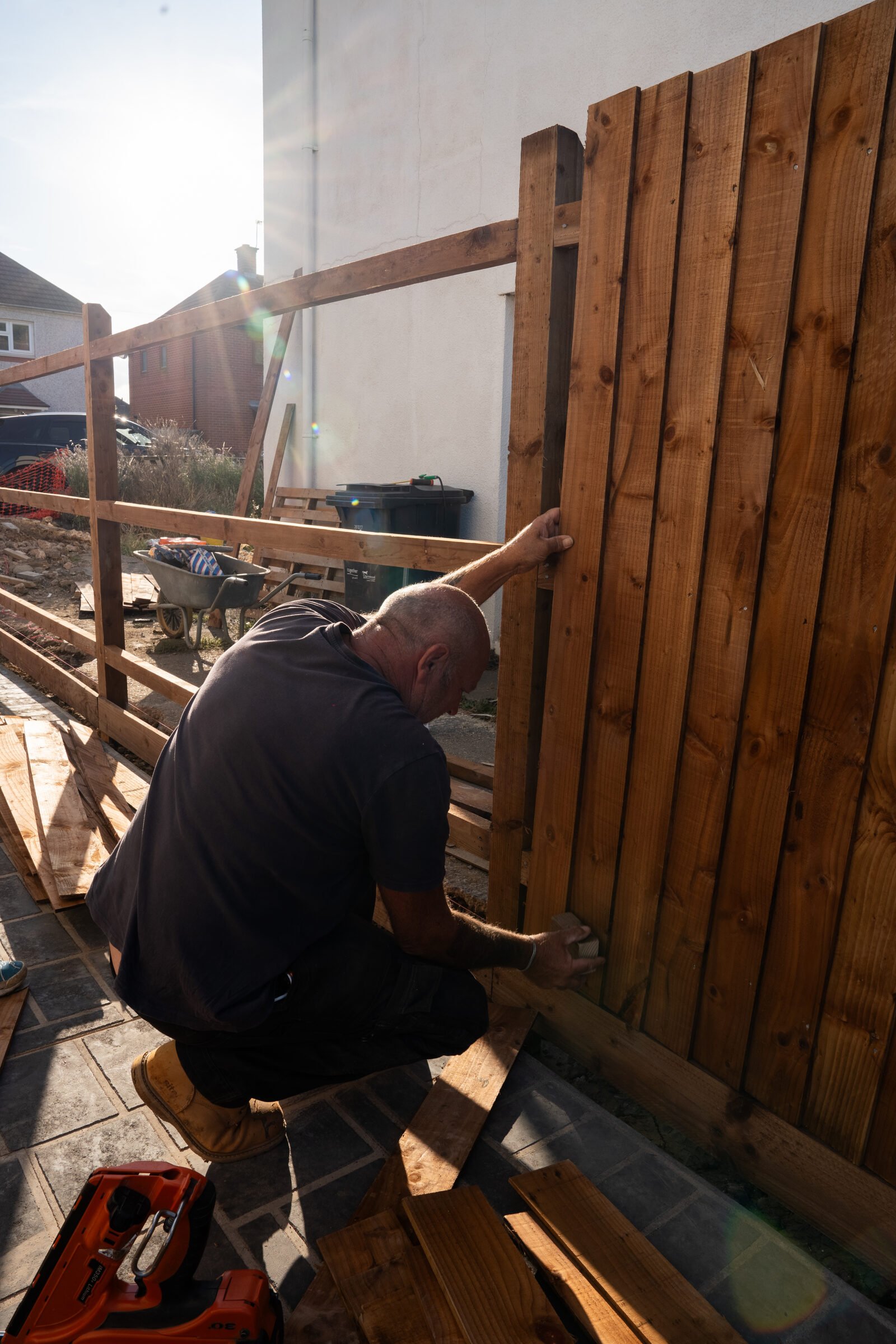 Timber boundary fence being installed beside a new driveway