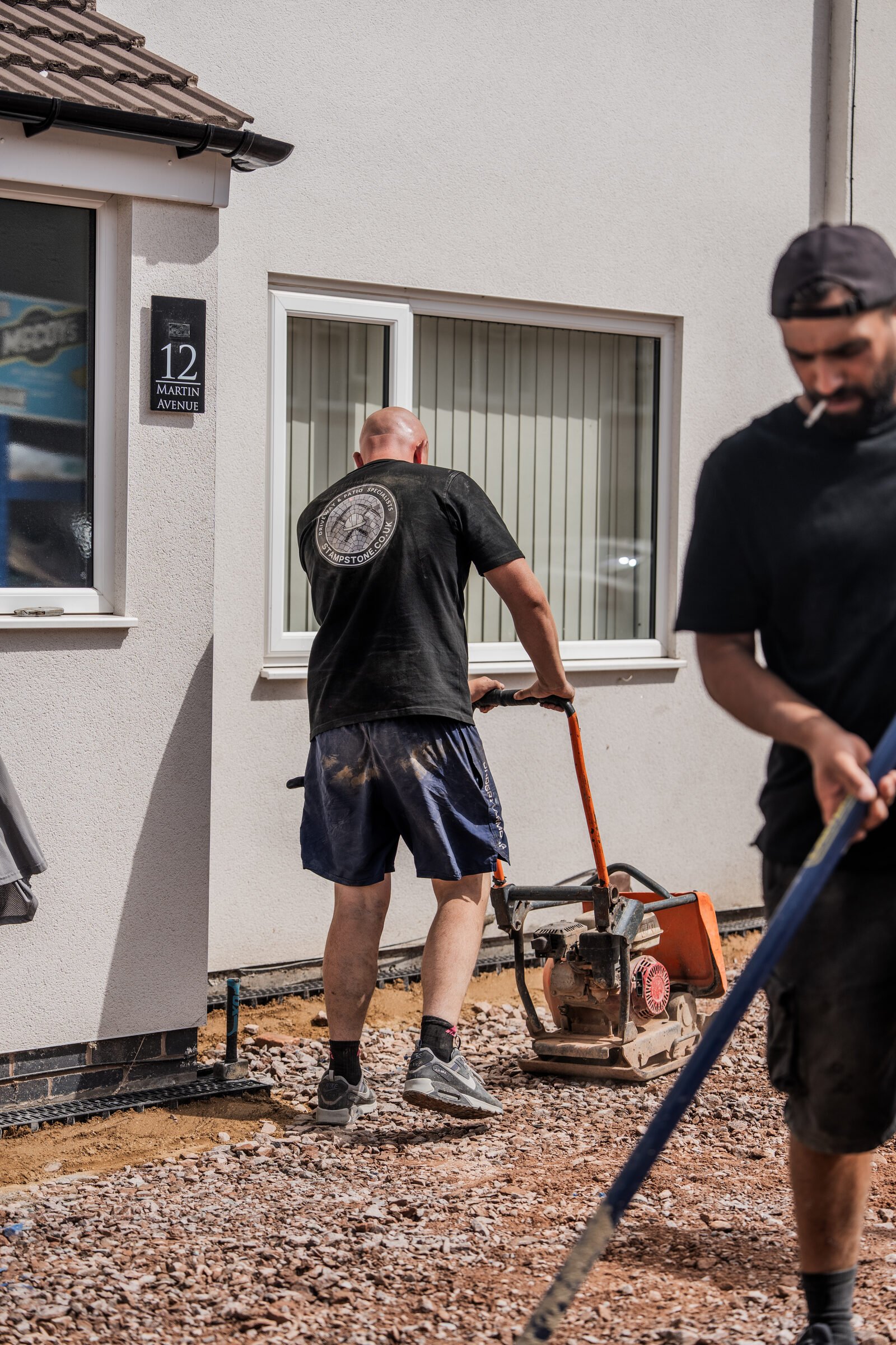 Stamp Stone team compacting and levelling the prepared driveway sub-base