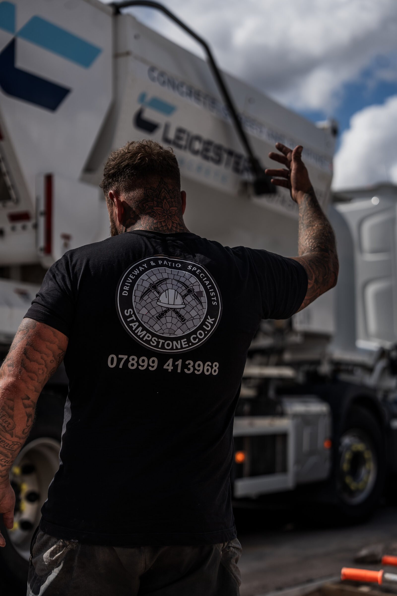 Stamp Stone team coordinating concrete delivery at a residential driveway project